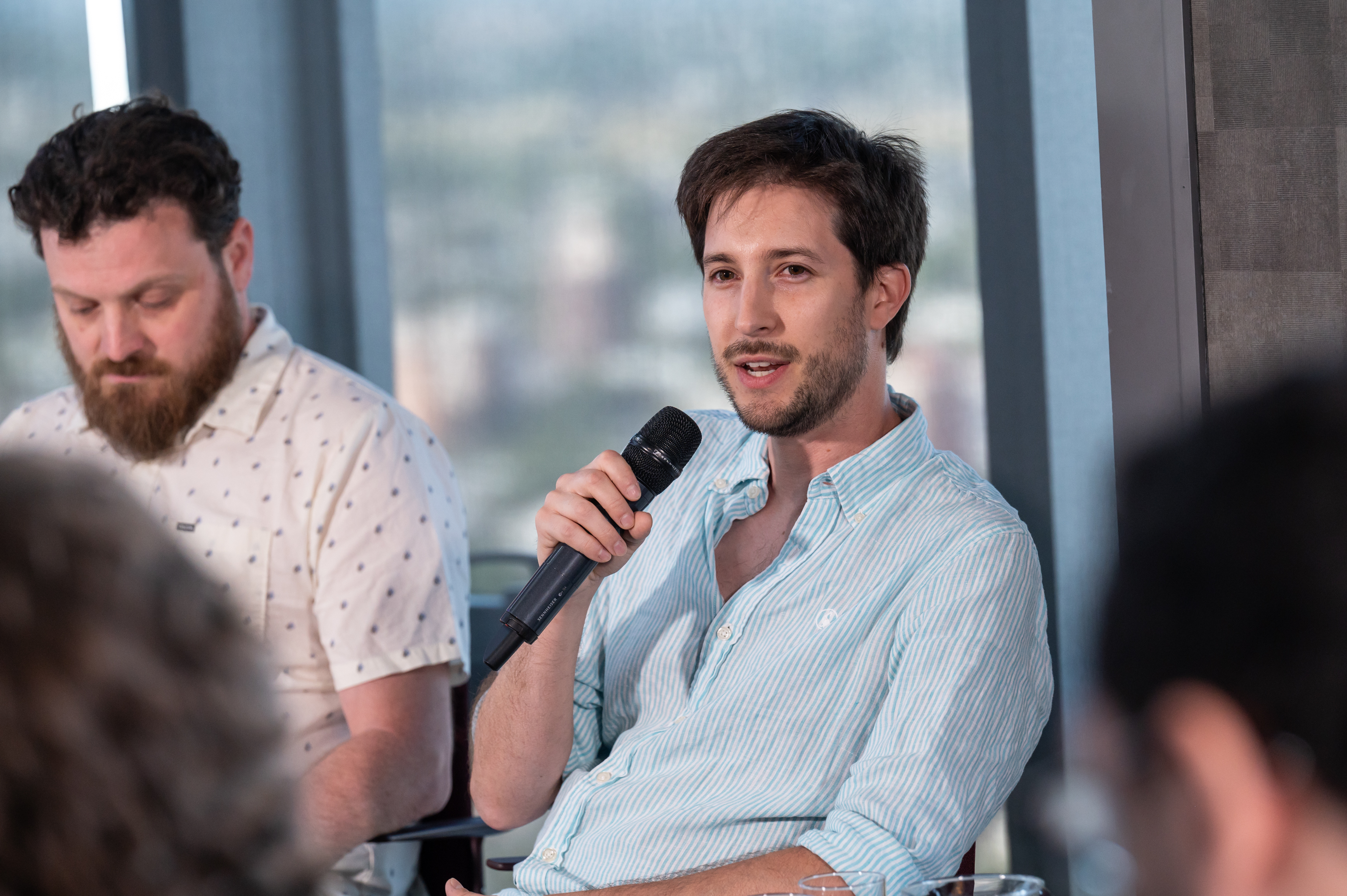 Nicolas Levy speaking into a microphone during a roundtable at Montevideo Tech Day