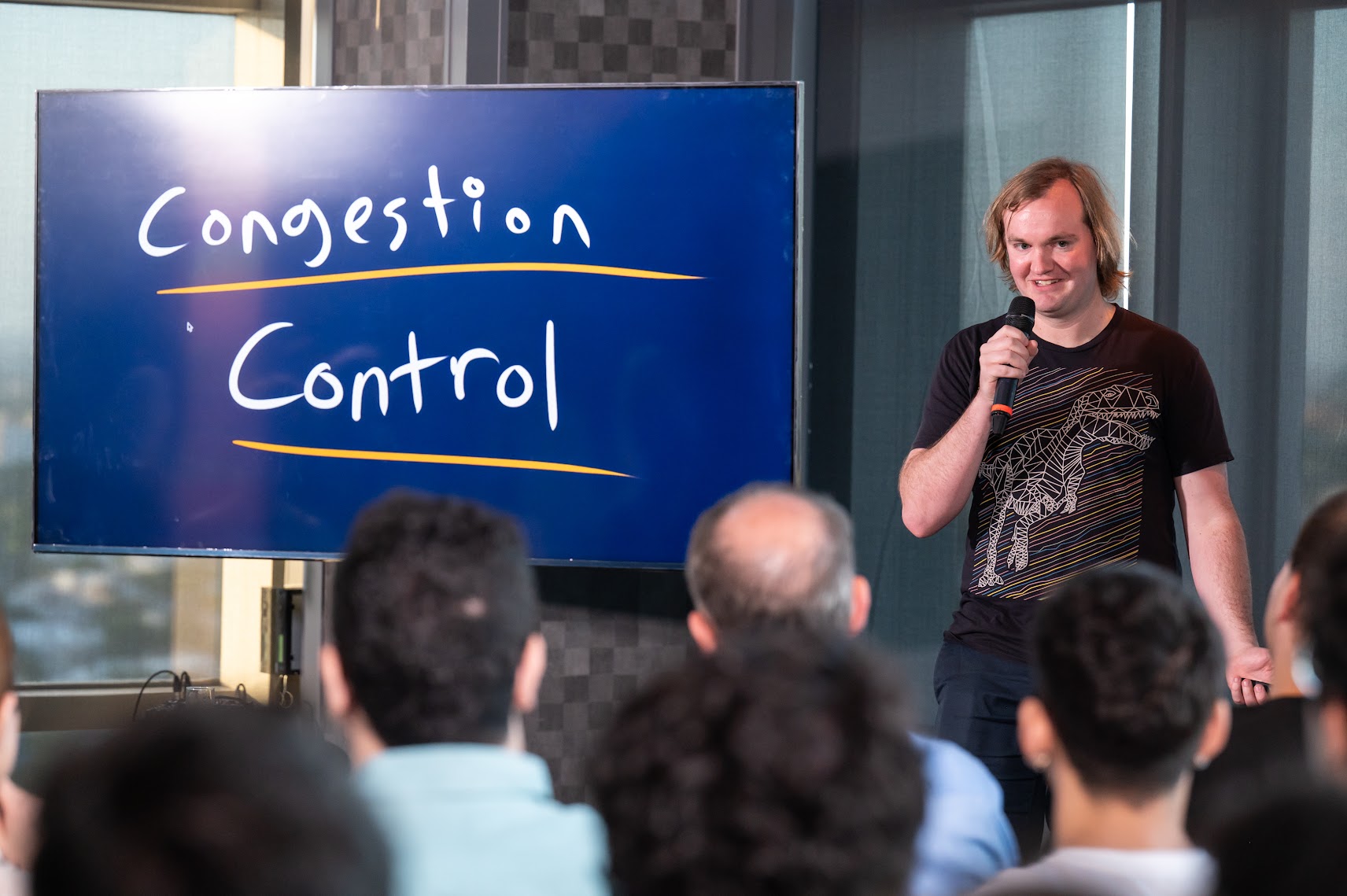 Speaker presenting a “Congestion Control” talk to the audience at MonteVIDEO Tech Day