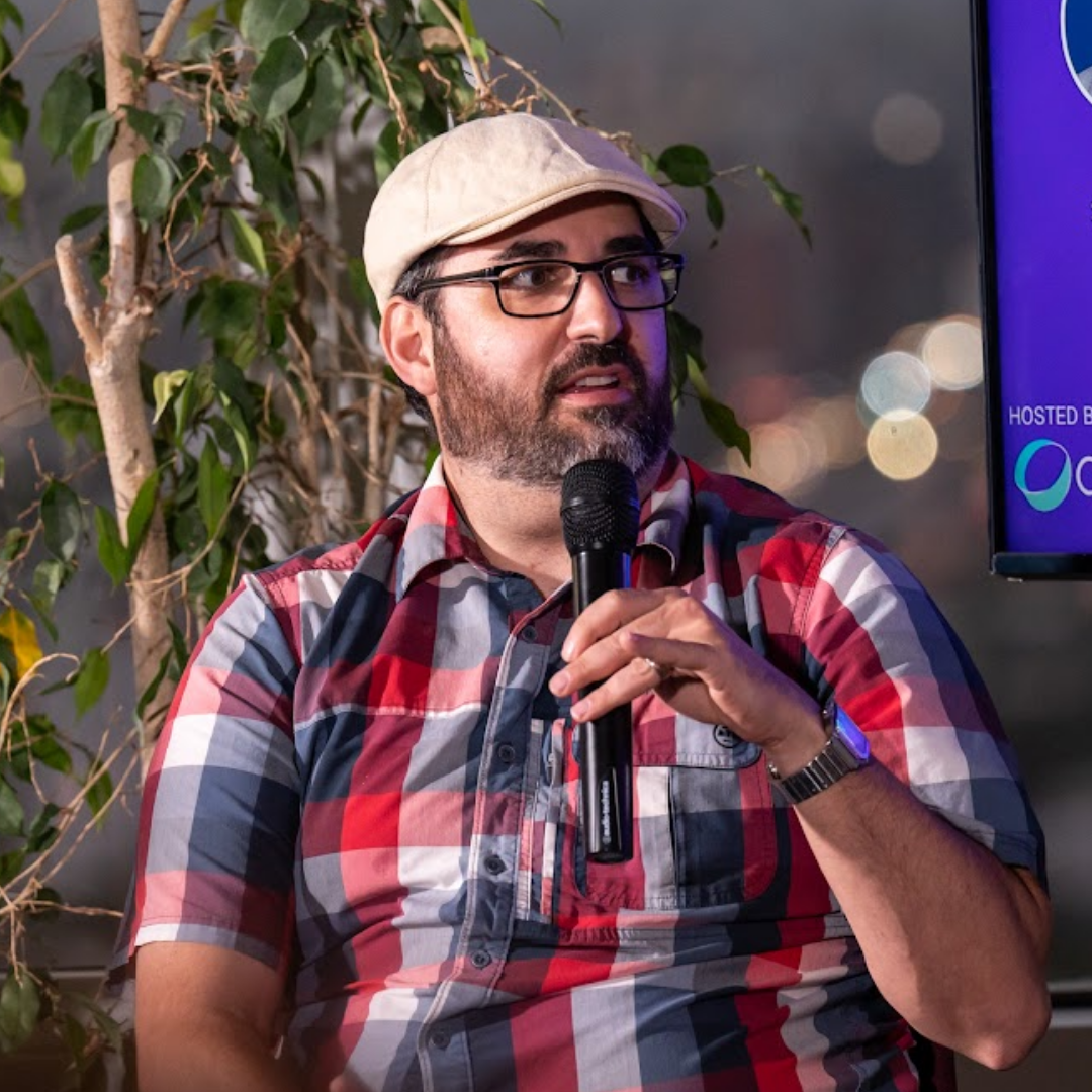 David Hassoun speaking into a microphone at a MonteVIDEO Tech event